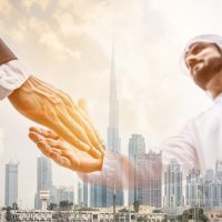 Double,Exposure,Of,Two,Business,Men,Over,Dubai,Skyline,Building